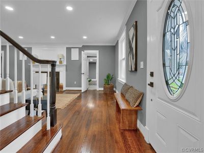 Entrance foyer featuring crown molding and dark hardwood / wood-style flooring | Image 3