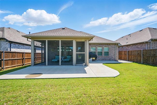Rear view of property featuring a sunroom, a patio area, and brick siding | Image 23