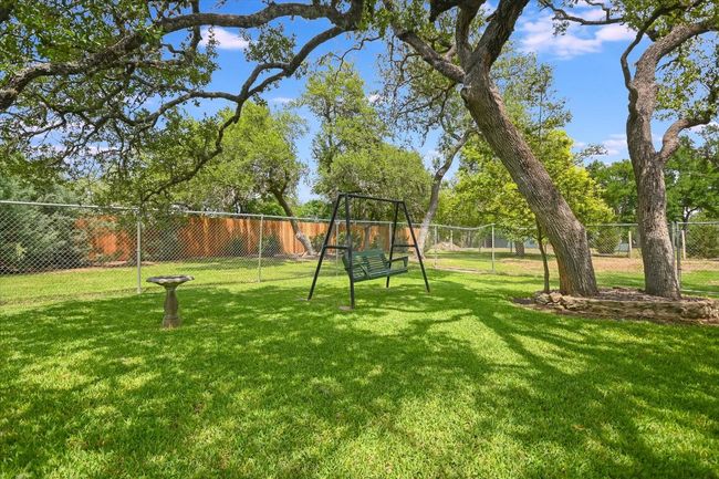 The chain link fencing is a large dog run. Beautiful shaded back yard. | Image 30