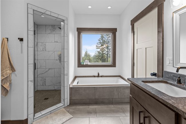 Bathroom with recessed lighting, tiled shower, tile patterned floors, vanity, and a garden tub | Image 28