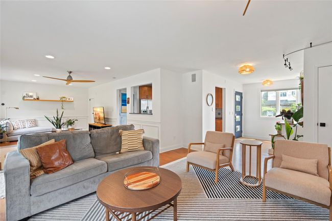 Living area featuring light wood-type flooring and a ceiling fan | Image 6