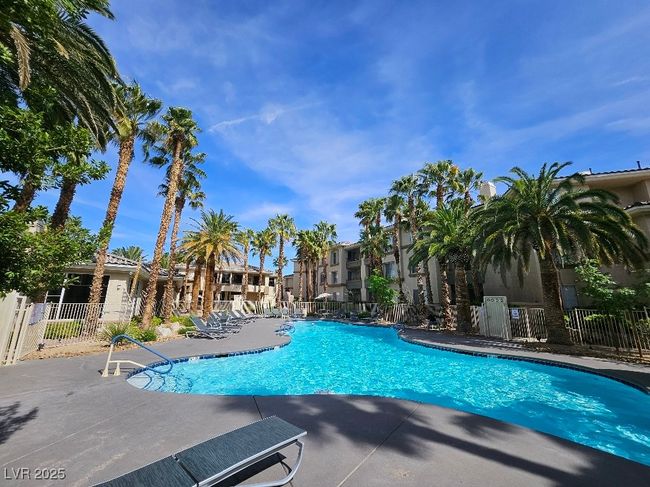 Community pool with a residential view, a patio, and fence | Image 5