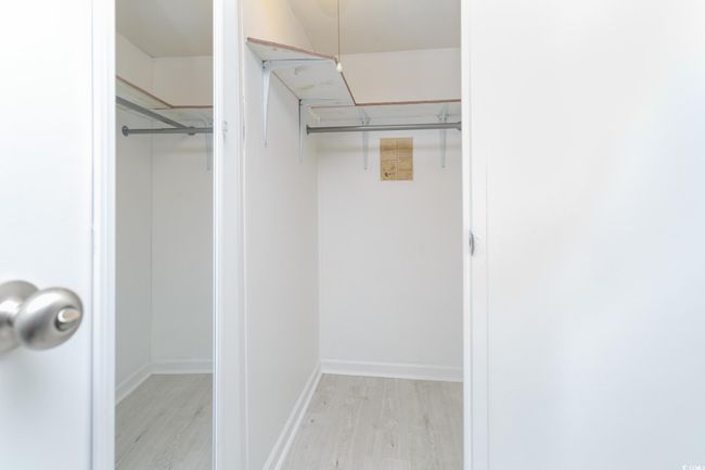 Walk in closet featuring light wood-style floors | Image 20