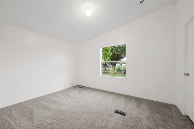 Bedroom 4 room with carpet floors, vaulted ceiling, and a textured ceiling | Image 21