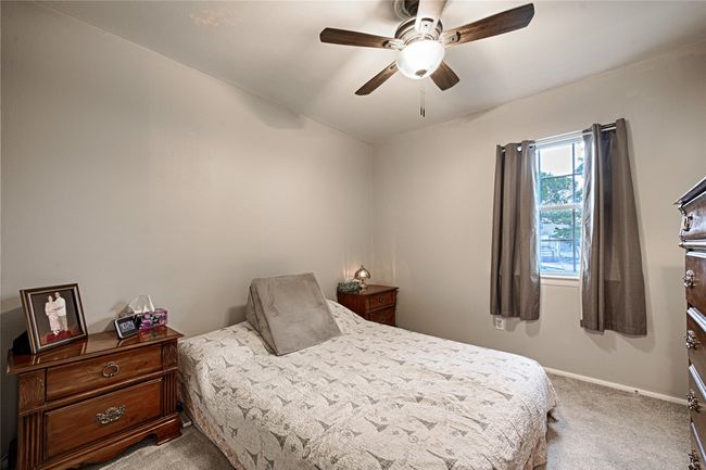 Newly carpeted secondary bedroom featuring baseboards and ceiling fan | Image 15