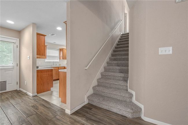 Stairs with wood finished floors and recessed lighting | Image 11