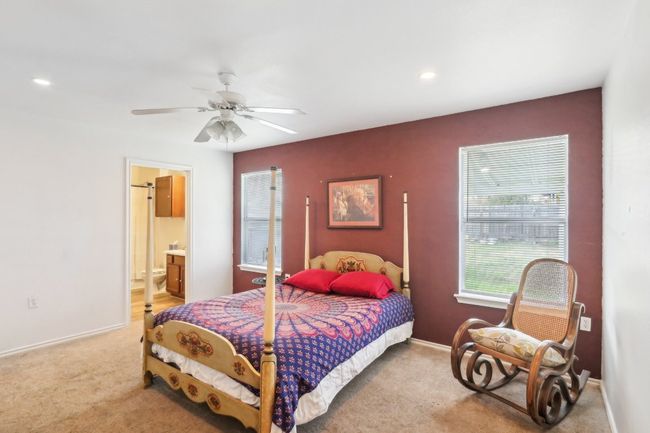 Carpeted bedroom featuring recessed lighting, baseboards, ceiling fan, and ensuite bath | Image 7