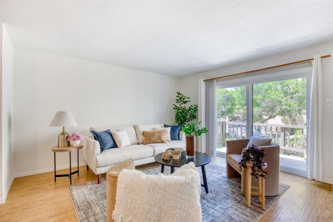 Living room with light wood-style floors and baseboards | Image 7