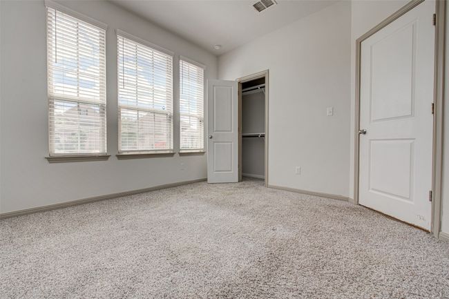 Unfurnished bedroom featuring carpet flooring, baseboards, and a closet | Image 5