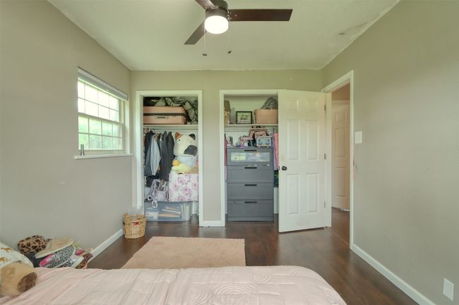 Bedroom with wood finished floors, a closet, and a ceiling fan | Image 34