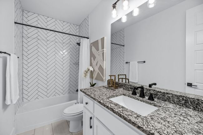 Full bathroom with vanity, tile patterned floors, shower / bath combo, and toilet | Image 18