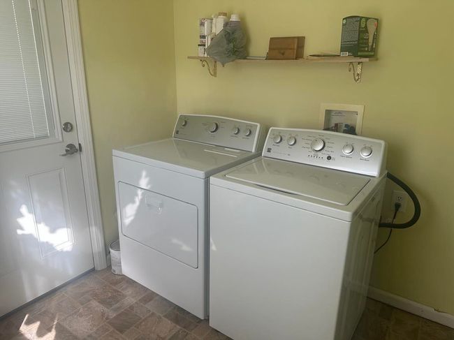 laundry room with door leading outside | Image 9