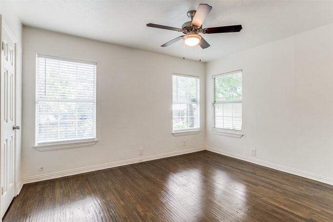 Spare room featuring dark wood-style floors and baseboards | Image 14