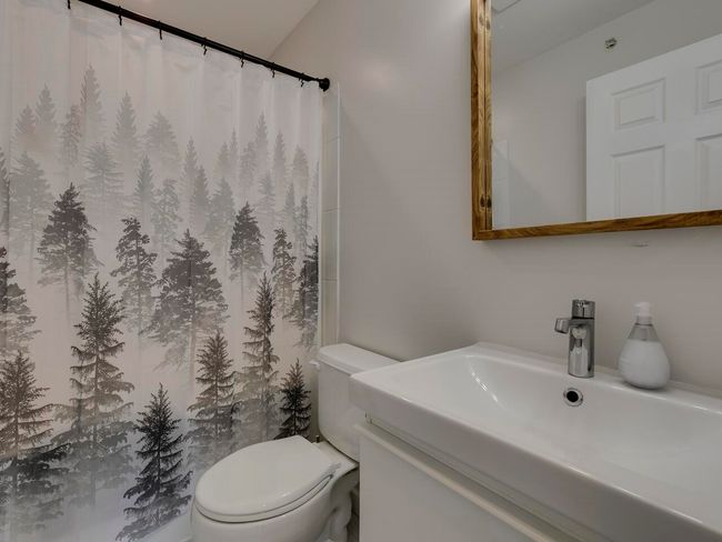 Bathroom featuring vanity, a shower with shower curtain, and toilet | Image 19