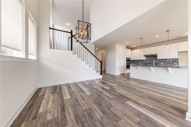 Large dining area open to staircase and dine-in kitchen. | Image 7