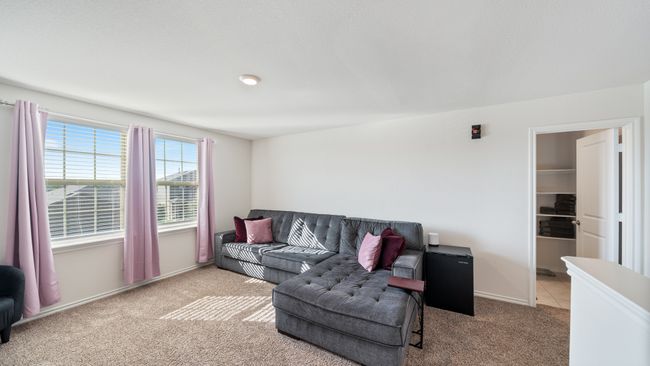Carpeted living room featuring baseboards | Image 23