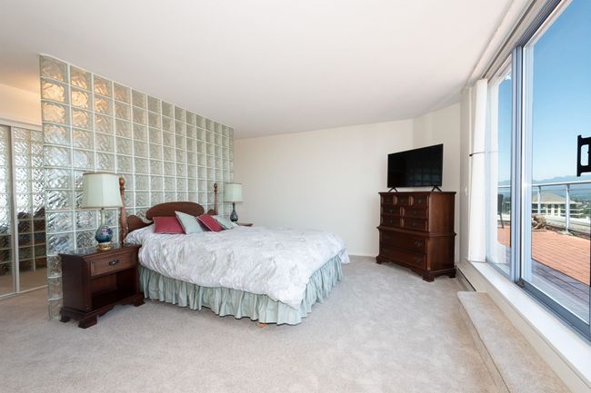 Bedroom with multiple windows and light carpet | Image 21
