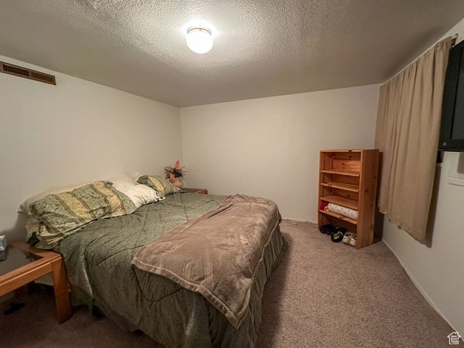 Bedroom with carpet flooring and a textured ceiling | Image 19