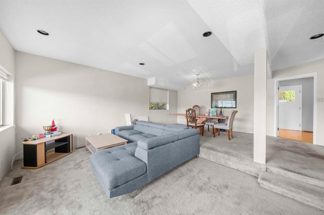 Living room with visible vents, an inviting chandelier, carpet, and a textured ceiling | Image 25