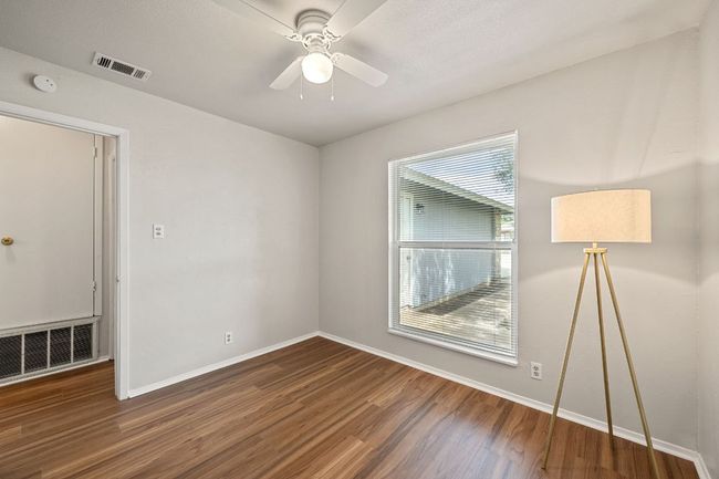 Secondary bedroom with ceiling fan. | Image 21