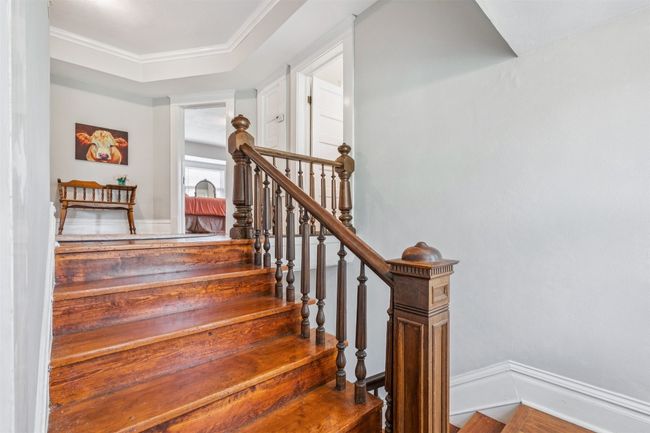Staircase featuring baseboards and crown molding | Image 22