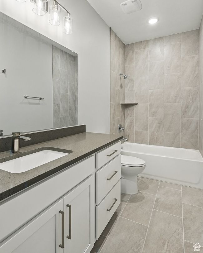 Bathroom featuring vanity, toilet, tub / shower combination, recessed lighting, and tile patterned floors | Image 46