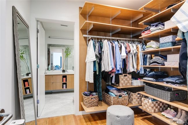 Primary walk in closet with generous custom shelving. | Image 32