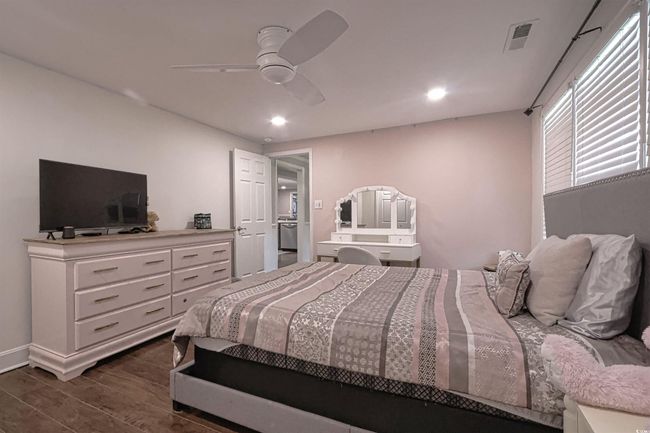 Bedroom with dark wood finished floors, recessed lighting, and a ceiling fan | Image 18