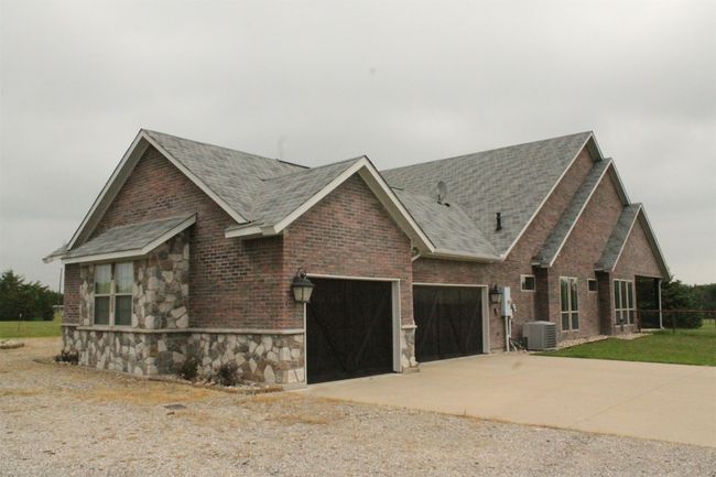 New landscaping south side of house. With 3 car garage | Image 35