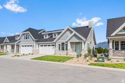 Craftsman-style house featuring a garage and covered porch | Image 2