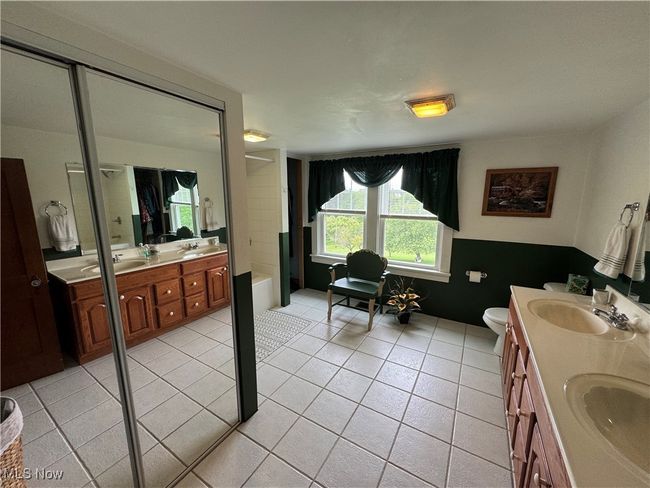 2nd floor Bathroom featuring double vanity, a tub, tile patterned flooring, and toilet | Image 30