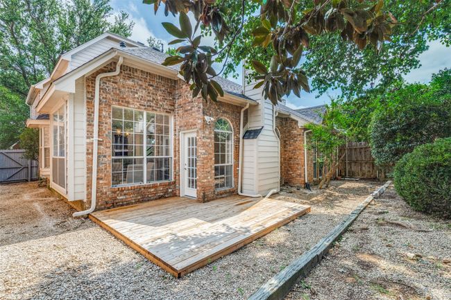Back of property featuring a deck, brick siding, roof with shingles, and a gate | Image 25
