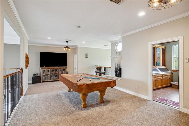 Game room with Juliet balcony overlooking downstairs living room. Fresh interior paint 2025 | Image 19