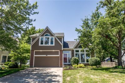 View of front of house with a garage and a front lawn | Image 1