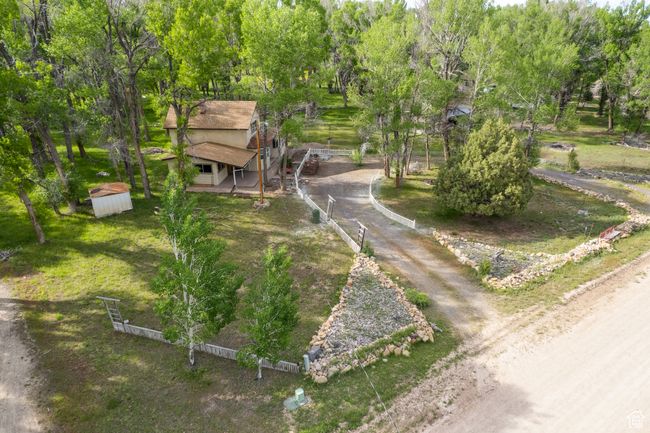 View of property's community featuring view of scattered trees and a shed | Image 44
