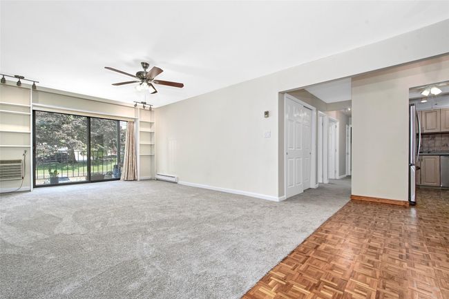 Spacious living room with a ceiling fan, new carpeting , SGD to balcony | Image 5