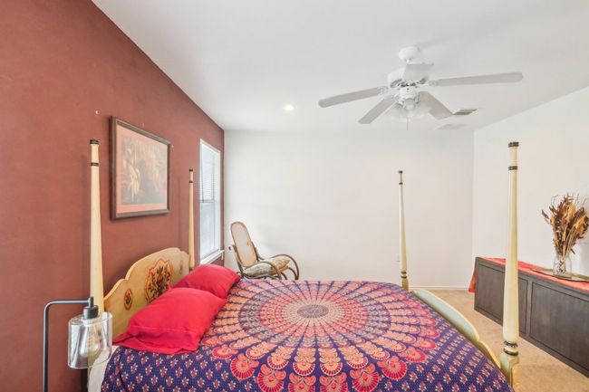 Bedroom featuring ceiling fan and light colored carpet | Image 9