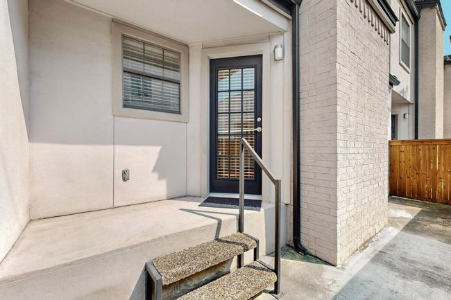 Doorway to property with brick siding and covered porch | Image 11