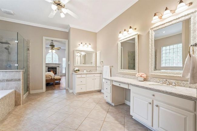 Spacious master bathroom features dual sinks with large mirrors, walk-in closets and frameless shower. | Image 31
