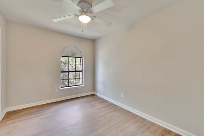 Secondary bedroom with walk-in closet and ceiling fan. | Image 27