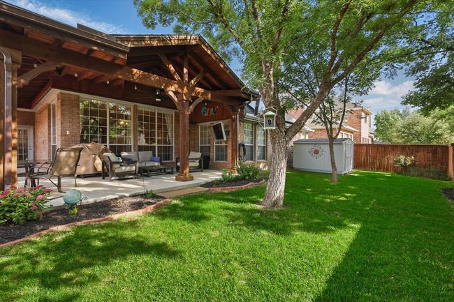 Back of property with a patio, a shed, brick siding, an outdoor hangout area, and an outdoor structure | Image 35