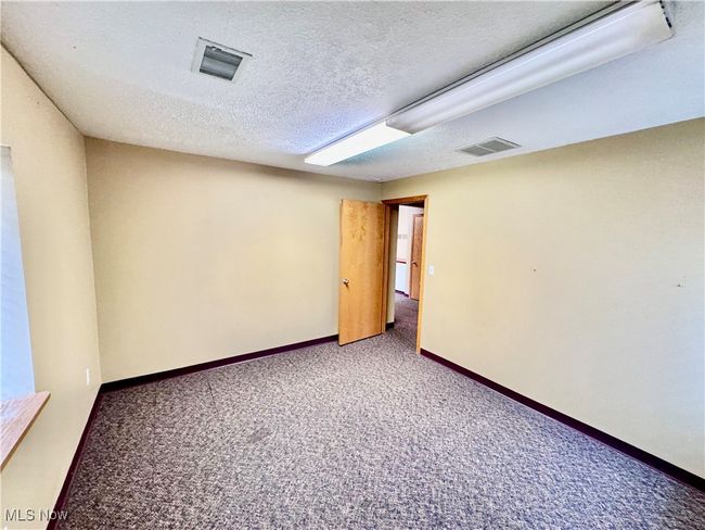 Unfurnished room with carpet floors and a textured ceiling | Image 14