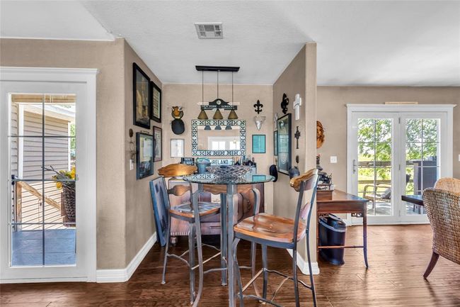 Dining area featuring wood finished floors and baseboards | Image 7