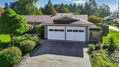 This home is amazing. Corner lot, fully fenced and surrounded with mature landscaping | Image 1