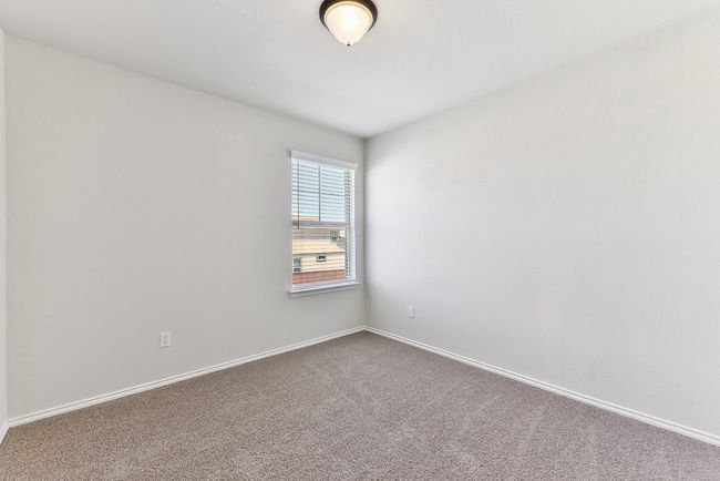 Spare room featuring baseboards and dark carpet | Image 25
