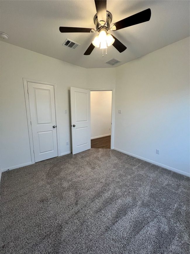 Unfurnished bedroom featuring dark carpet and ceiling fan | Image 27