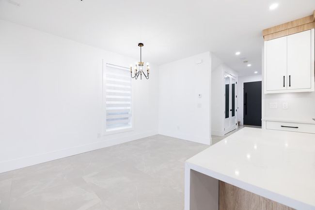 Unfurnished dining area with a chandelier and recessed lighting | Image 18