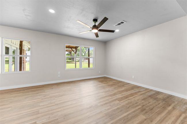 Spare room with light wood finished floors, a ceiling fan, baseboards, and recessed lighting | Image 8