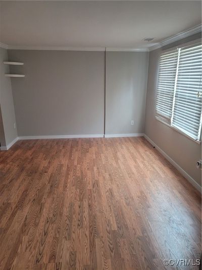 Empty room with crown molding and hardwood / wood-style flooring | Image 3