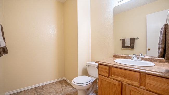 Half bath featuring toilet, vanity, and baseboards | Image 13